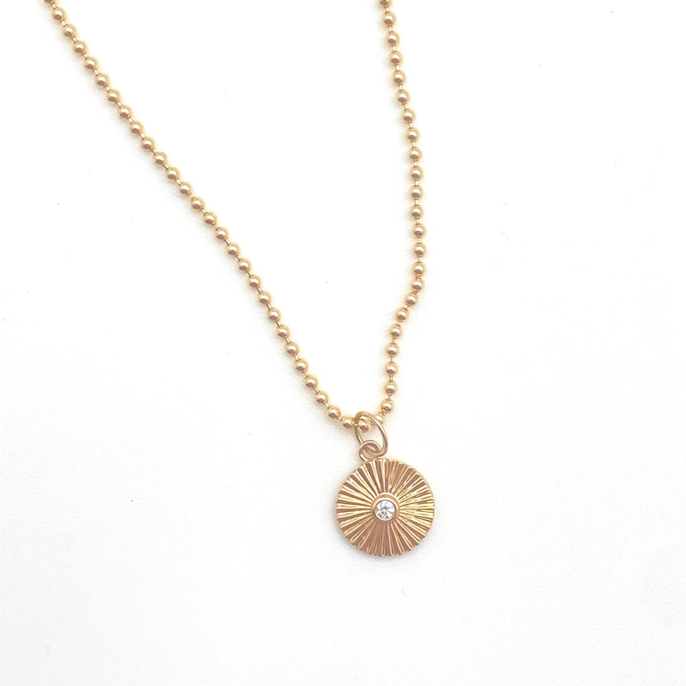 Fluted gold disc with diamond charm